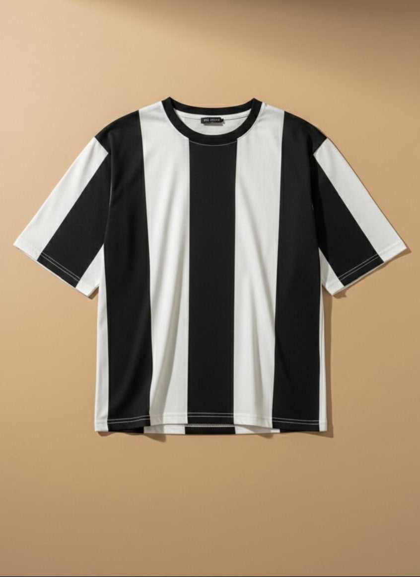 A short-sleeve crewneck t-shirt with bold vertical black and white stripes, displayed flat against a warm beige background.