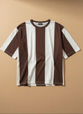 A short-sleeve crewneck t-shirt with vertical brown and white stripes, laid flat against a solid beige background.
